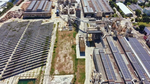 Factory complex with solar panels and industrial structures during daylight Stock Footage 341575631
