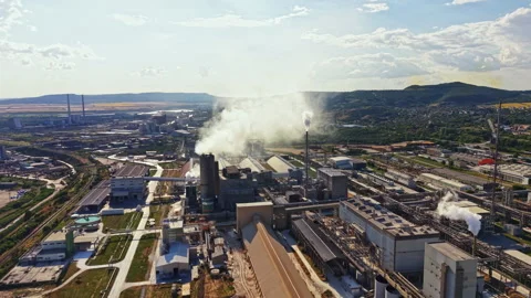Factory complex with tall chimneys and smoke over industrial area in daylight Stock Footage 340882498