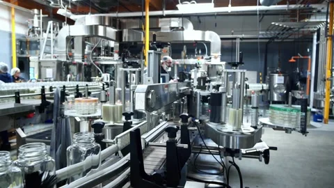 Factory conveyor line for processing and bottling juice into glass bottles.  Stock Footage 131810025