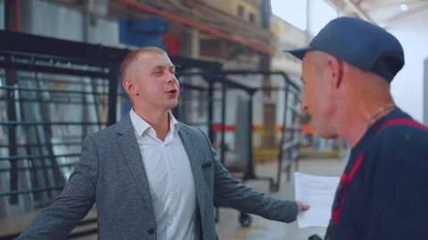 The factory director is talking to a worker Stock Footage 249534650