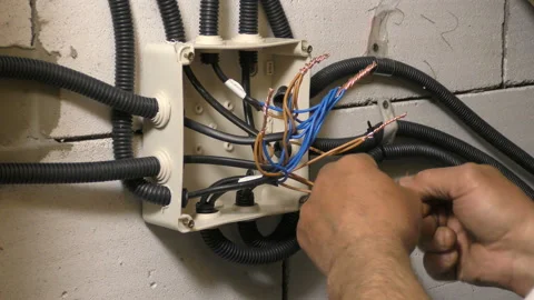 Factory electrician engineer installing cables with screwdriver Stock Footage 106926275