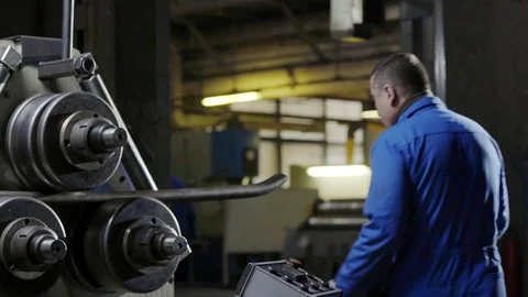 Factory employee using metalworking machine for electronic turning metal pipe Stock Footage 83530696