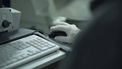 The factory employee works at the computer, assigns tasks. prepares to work Stock Footage 84043536