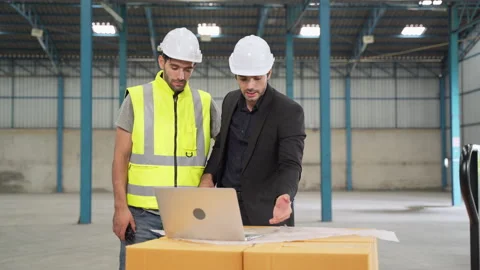Factory engineer brainstorming on warehouse work problems. Stock Footage 155696450