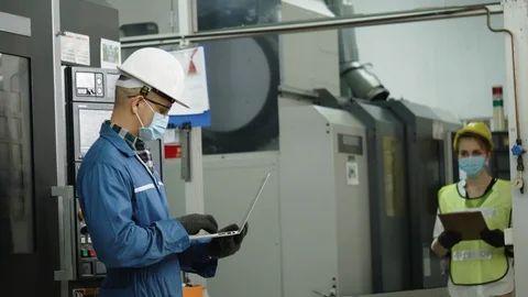 Factory engineer check machine equipment. Safety helmet to prevent accidents. Stock Footage 128912039