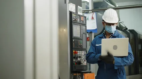 Factory engineer check machine equipment. Safety helmet to prevent accidents. Stock Footage 128912137