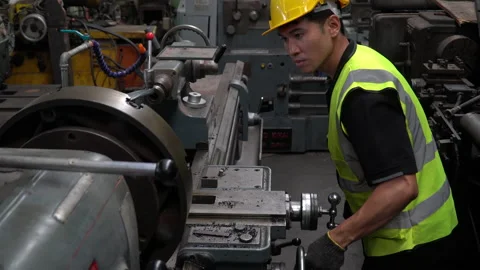 Factory Engineer control lathe machine in the industrial plant Stock Footage 139096953