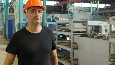 Factory engineer in hardhat walking through industrial manufacturing facility Video stock 116262267