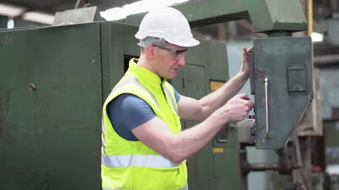 Factory Engineer inspecting and controlling machinery and talking with team Stock Footage 139096964