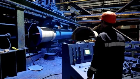 Factory engineer operates pipe painting automatic machine Stock Footage 311131270