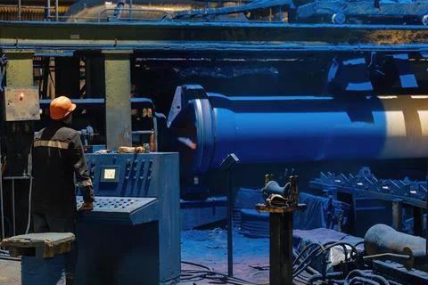 Factory engineer operates pipe painting automatic machine Stock Photos