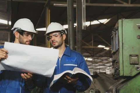 Factory Engineer or mechanical worker  checking on production in a factory. Stock Photos