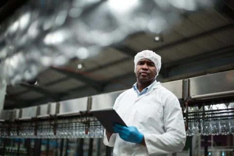 Factory engineer using digital tablet in the factory Stock Photos