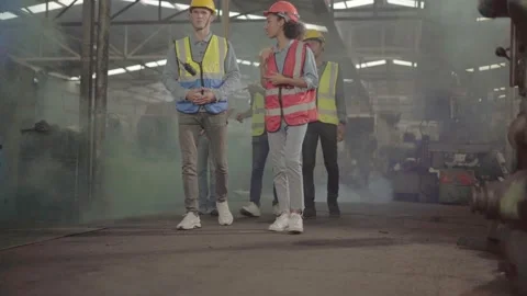A factory engineer wearing a red helmet is introducing an industrial plant to Stock Footage 170244338