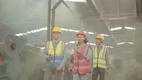 A factory engineer wearing a red helmet is introducing an industrial plant to Stock Footage 170244350