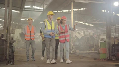A factory engineer wearing a red helmet is introducing an industrial plant to Stock Footage 170244370