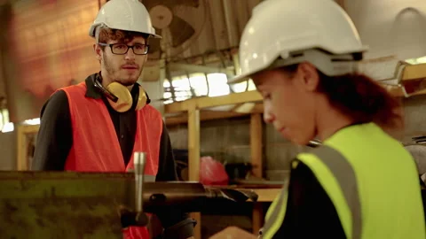 Factory engineers and buddy are inspecting machines inside an industrial Stock Footage 169313921