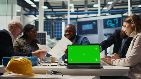 Factory engineers refining production layouts using chroma key laptop Stock Footage 306109255