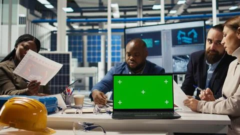 Factory engineers use green screen laptop to check PV materials parameters Stock Photos
