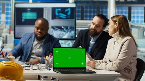 Factory engineers use green screen laptop to check PV materials parameters Stock Photos