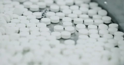 Factory equipment and machine. Closeup view of drugs move along conveyor belt. Stock Footage 238368368