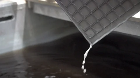 Factory equipment at work. Liquid is draining from the plate. Stock Footage 128957367