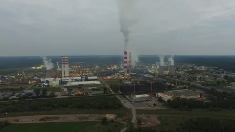 Factory in the evening, next to a passing train, aerial view Stock Footage 86860503