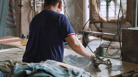 Factory Female Worker Irons New Denim Jeans with Heavy Industrial Steam Iron Видео 341548574