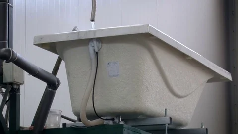 Factory. Fitting Shop. White Cast Iron Bathtub Standing up High. Hot Water Stock Footage 71993871