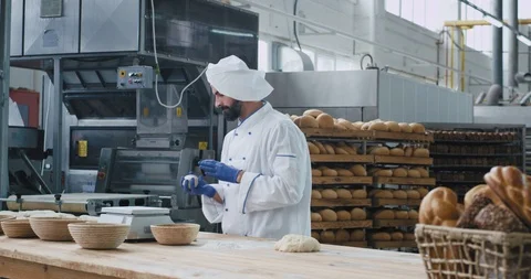 Factory food bakery dancing baker in the commercial kitchen listening music from Stock Footage 122938004