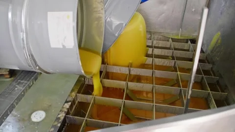 Factory homogenizer with honey being put into it from barrels Stock Footage 248363484