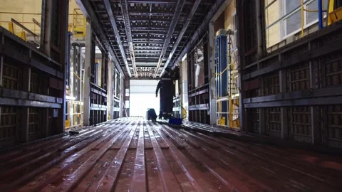 Factory labors in protective suits and safety masks welding steel structures and Stock Footage 202049078