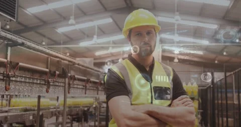 Factory line lead hard hat vest standing arms crossed, camera zooming revealing Stock-Footage 331085380