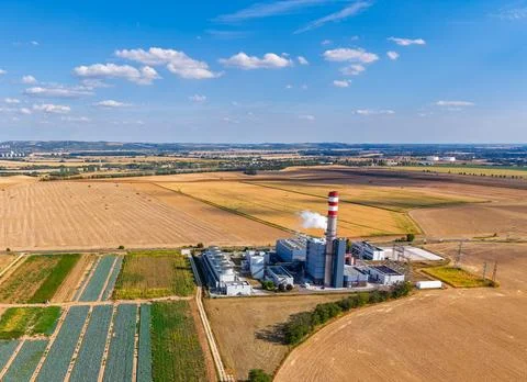 Factory located in a rural area with fields and blue sky in the background... Stock Photos