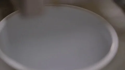 Factory machine filling buckets with syrup Stock Footage 72559015