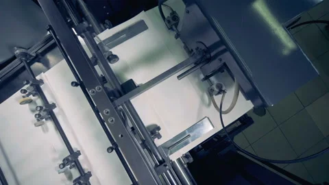 Factory machine moves paper on a conveyor, top view. Paper production machine Stock Footage 90837084