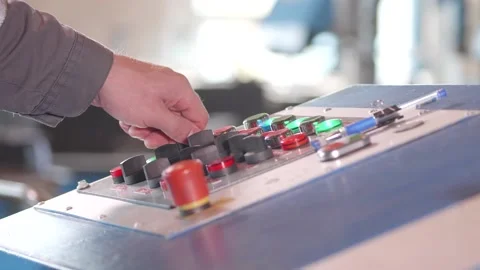 At the factory, the machine operator turns on and off the functions Stock Footage 170698562