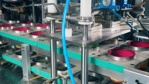 Factory machine is relocating plastic boxes and filling them. Packing process at Stock Footage 115105806