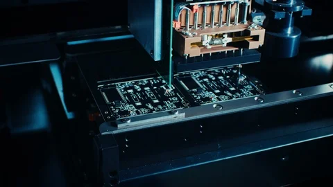Factory Machine at Work: Printed Circuit Board Being Assembled with Robotic Arm Stock Footage 98188380