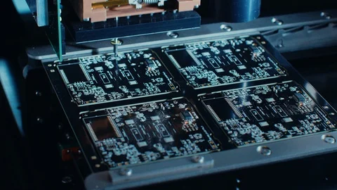 Factory Machine at Work: Printed Circuit Board Being Assembled with Robotic Arm Stock Footage 98188957