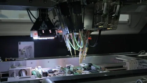 Factory Machine at Work: Printed Circuit Board Being Assembled with Automated Stock Footage