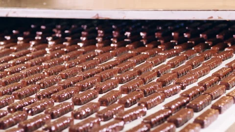 Factory machinery with plenty of chocolate sweets moving along Stock Footage 150198565