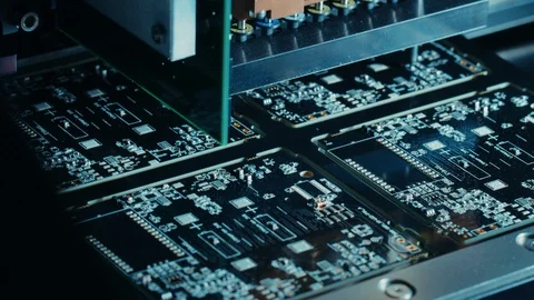 Factory Machinery at Work Printed Circuit Board Being Assembled with Robotic Arm Stock Footage