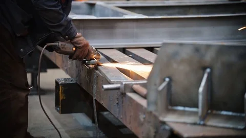At the factory, a man grinds a small metal part Stock Footage 110486187