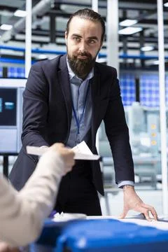Factory management executives looking over paperwork documents 스톡 사진