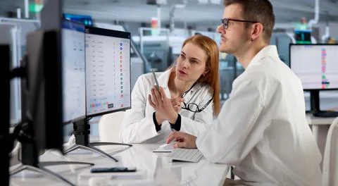 Factory Manager Monitors Real-time Production Data On Desktop Computer. Stock Photos