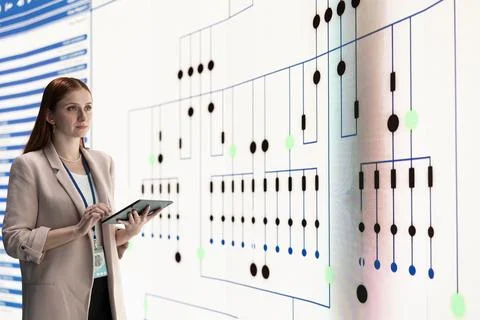 Factory manager oversees microprocessor production on large screen Stock Photos