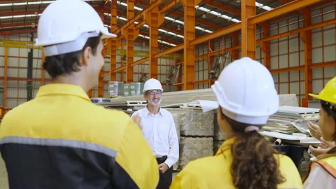 Factory manager is training foreman and group of workers in morning. Stock Footage 237974767