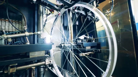 Factory mechanism is manufacturing bicycle wheels Stock Footage