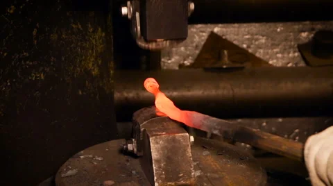 Factory Metalwork. Blacksmith Holding Hot Iron Rod. Mechanical Anvil Hitting on Stock Footage 68617392